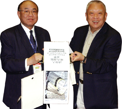 The Chief Executive joins the Chairman of the Electoral Affairs Commission, Mr Justice Woo Kwok-hing, to empty ballot boxes during the Legislative Council Election.