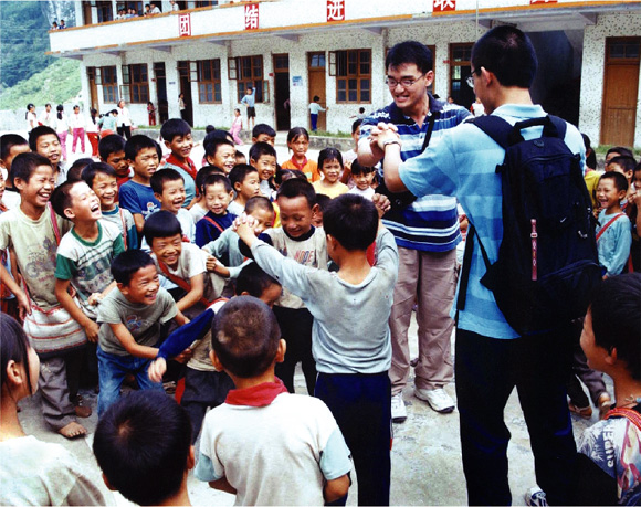 Hong Kong Christian volunteers extend a playful hand to children in Guangzhou.